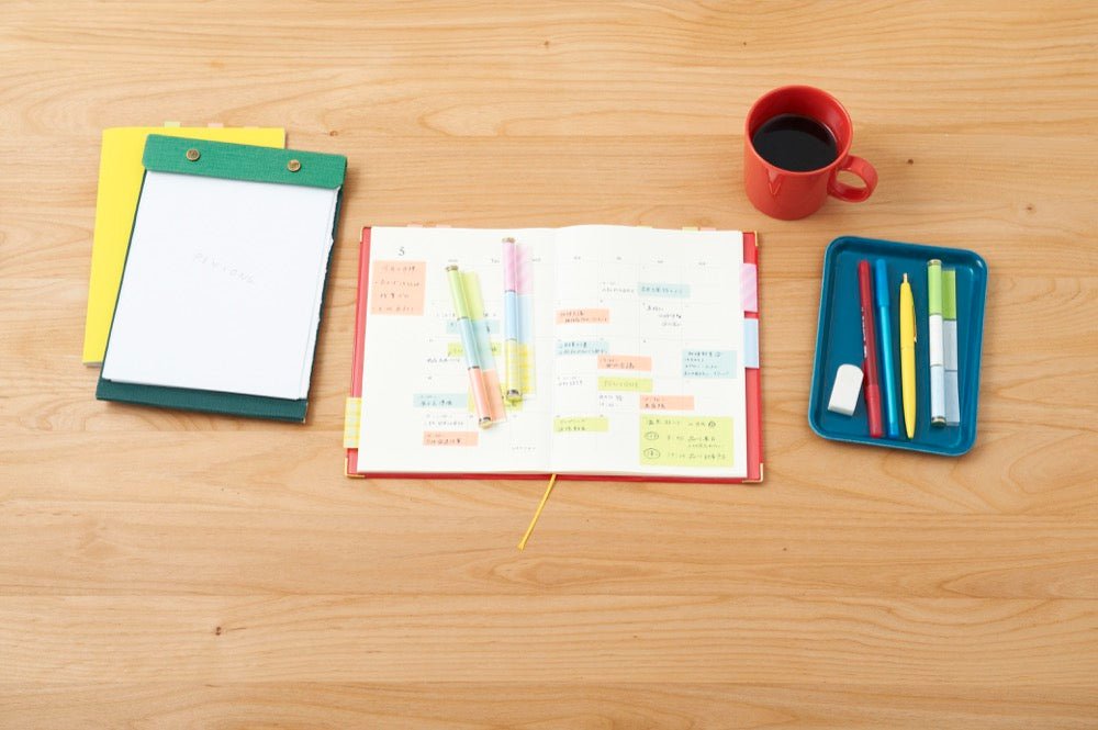 Table with open notebook and PENtONE Sticky Notes